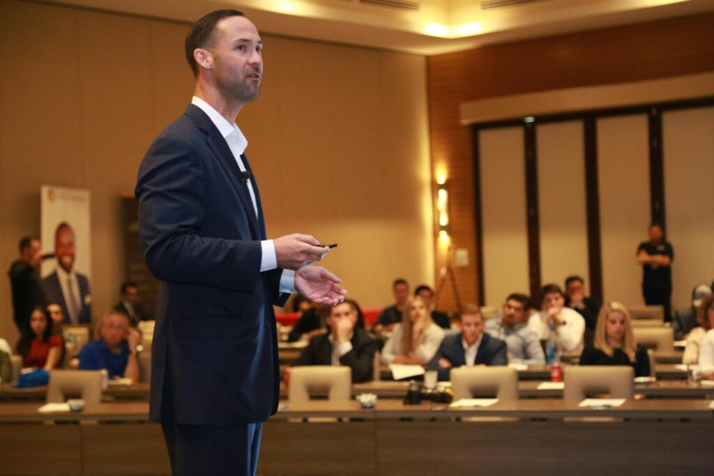 James Bleier A dynamic speaker engages professionals during a business conference presentation.